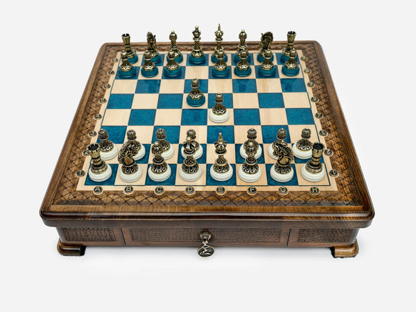 Blue epoxy chess set with bronze pieces set up for play, front view