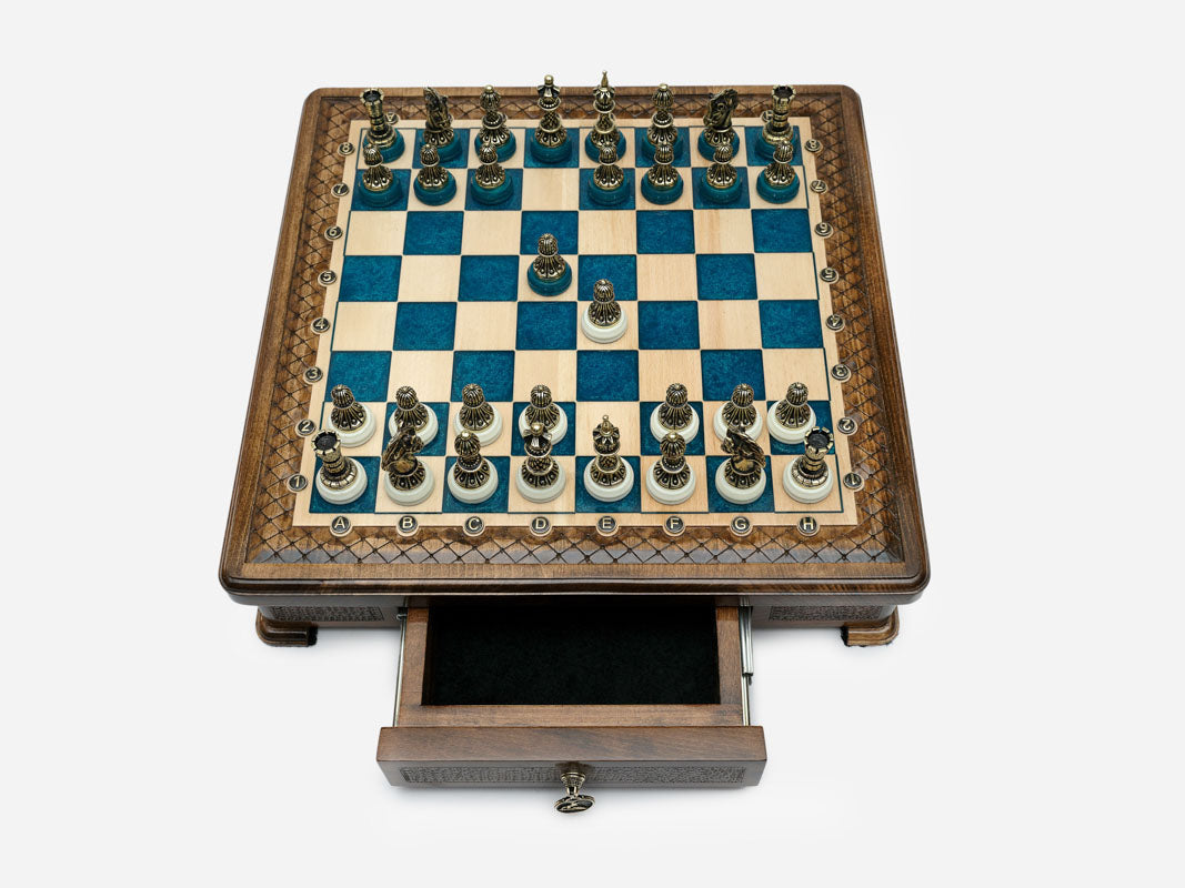 Blue epoxy chess set top-down view with pieces set up and drawer open