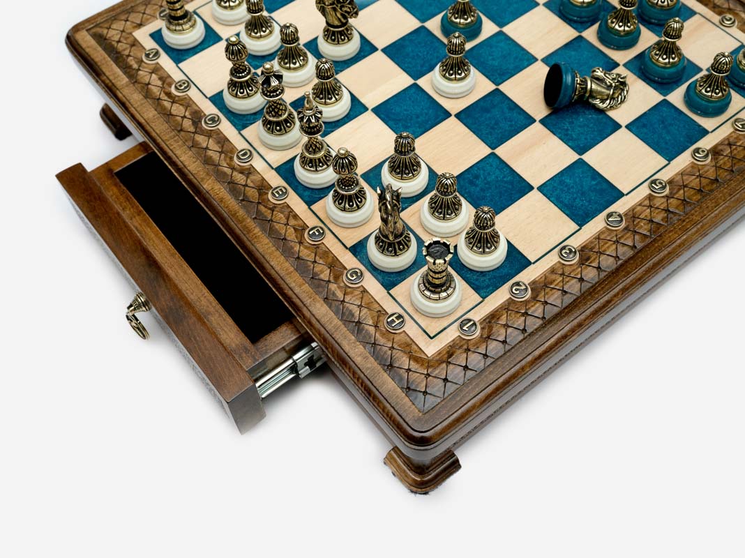 Close-up of the blue epoxy chess set drawer corner with bronze pieces
