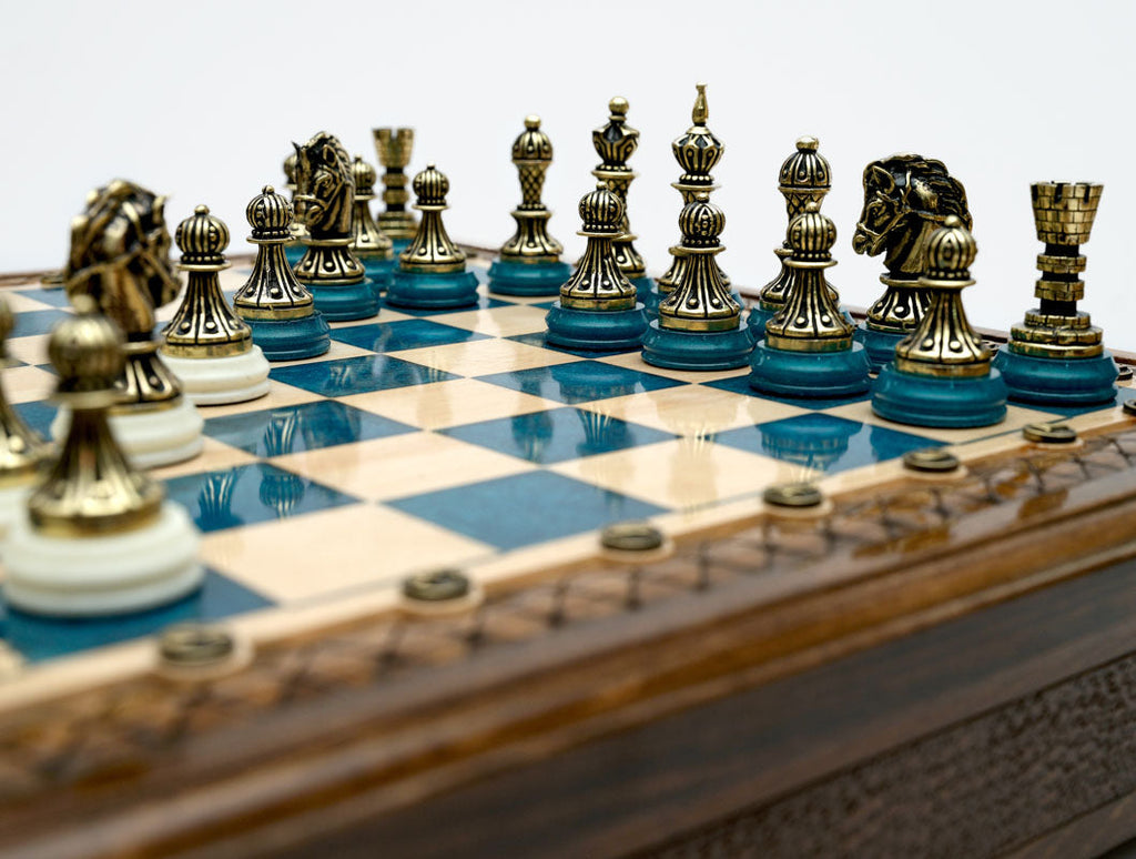 Close-up of the bronze chess pieces on the blue epoxy board