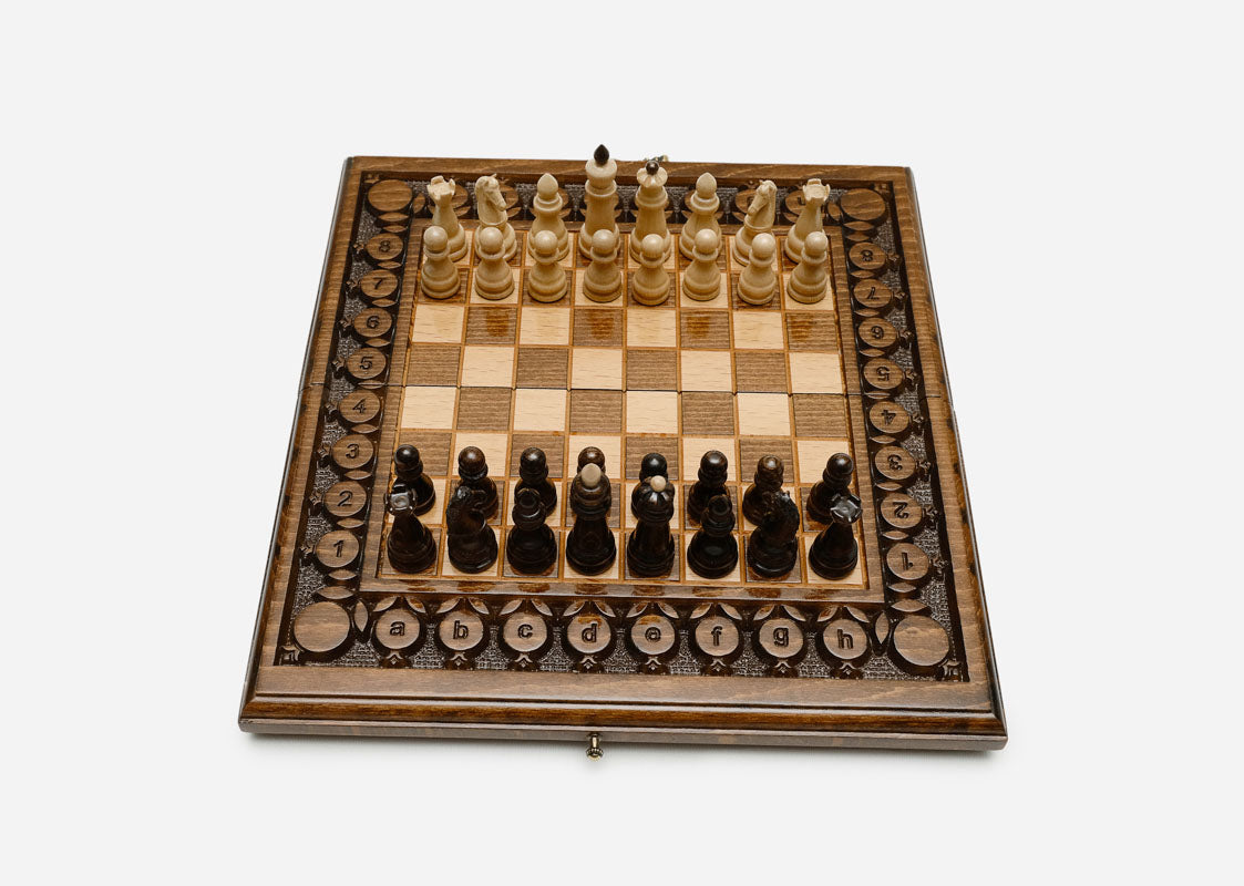 Pomegranate and grapevine hand-carved on a wooden chess board - detail
