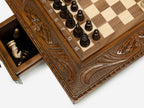 Close-up of a side drawer open with wood chess pieces stored inside