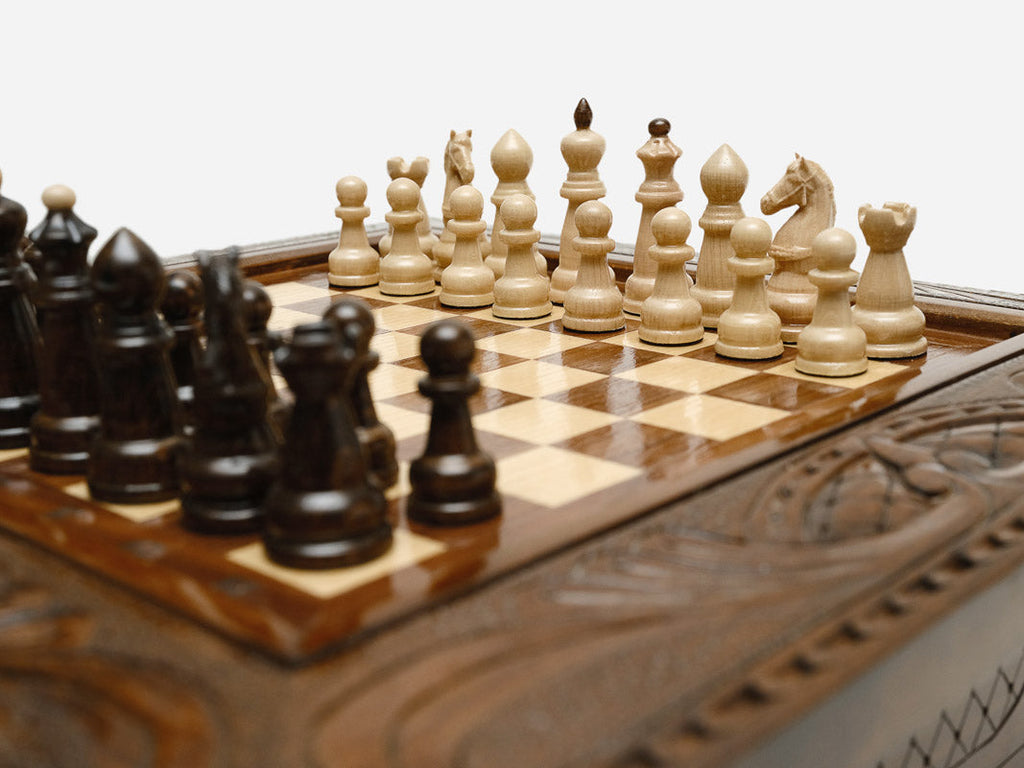 Close-up of the classic wood chess pieces on the board