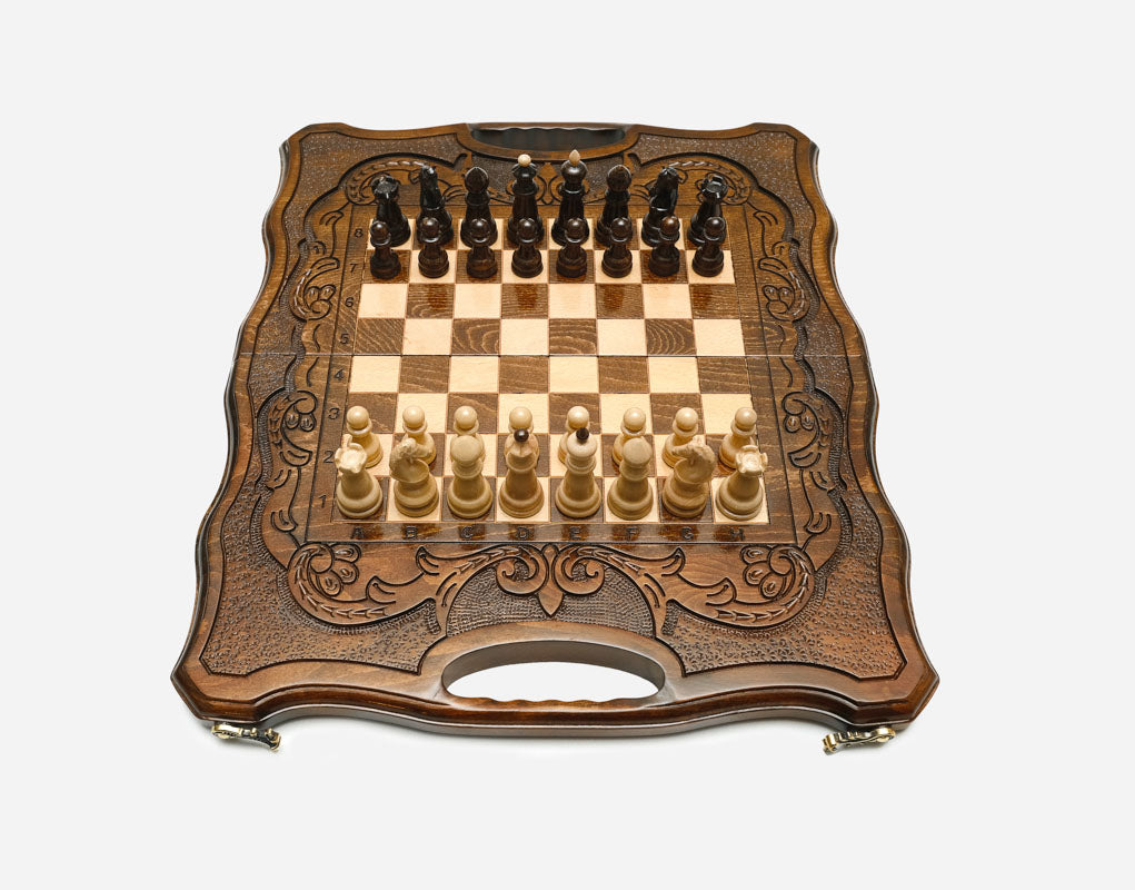 Top-down view of the opened board with its carved borders and full set of pieces