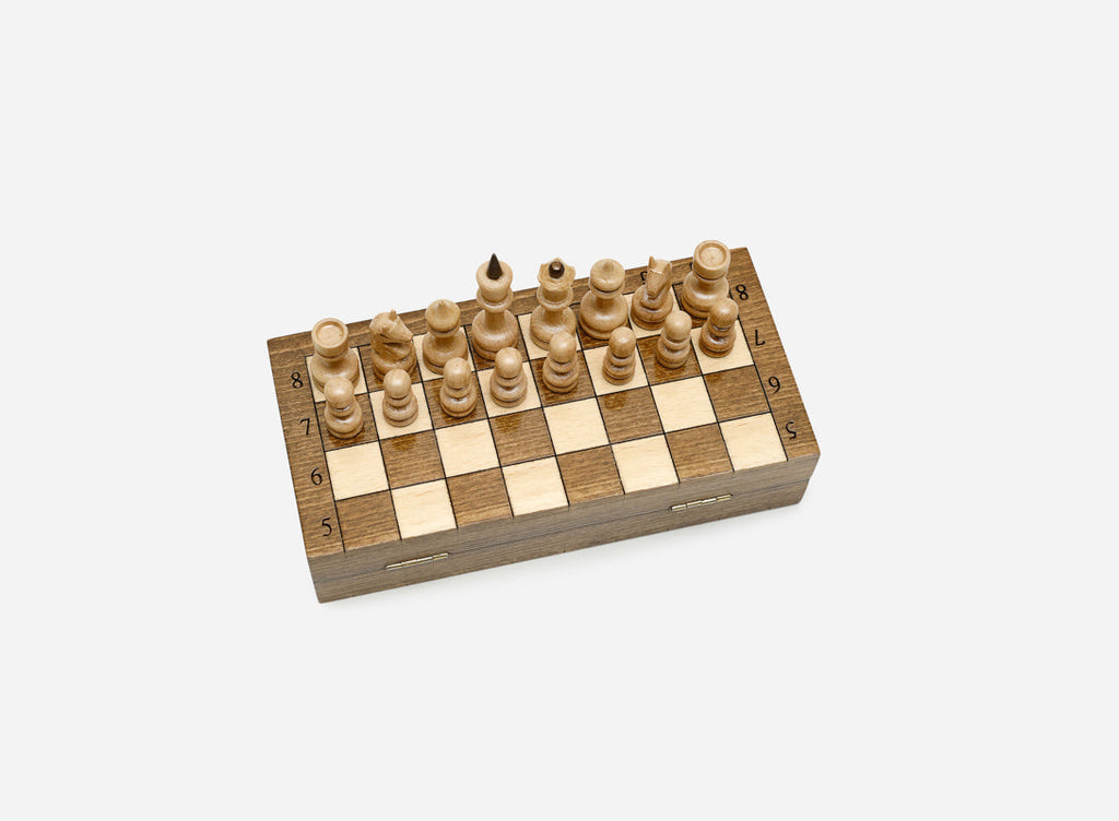 Compact wooden chessboard with turned pieces