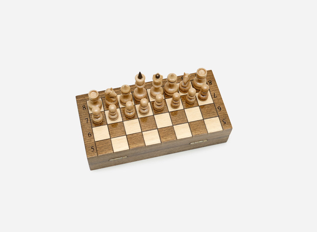 Compact wooden chessboard with turned pieces