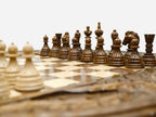 Macro view of the hand-turned beech and walnut chess pieces