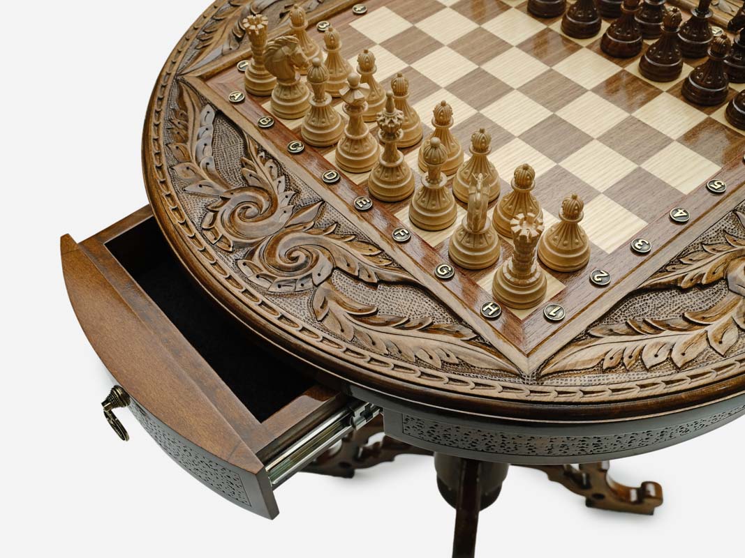 Close-up of the carved apron, inlaid chessboard and brass notation markers