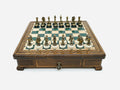 Green epoxy chess set with bronze pieces set up for play, front view