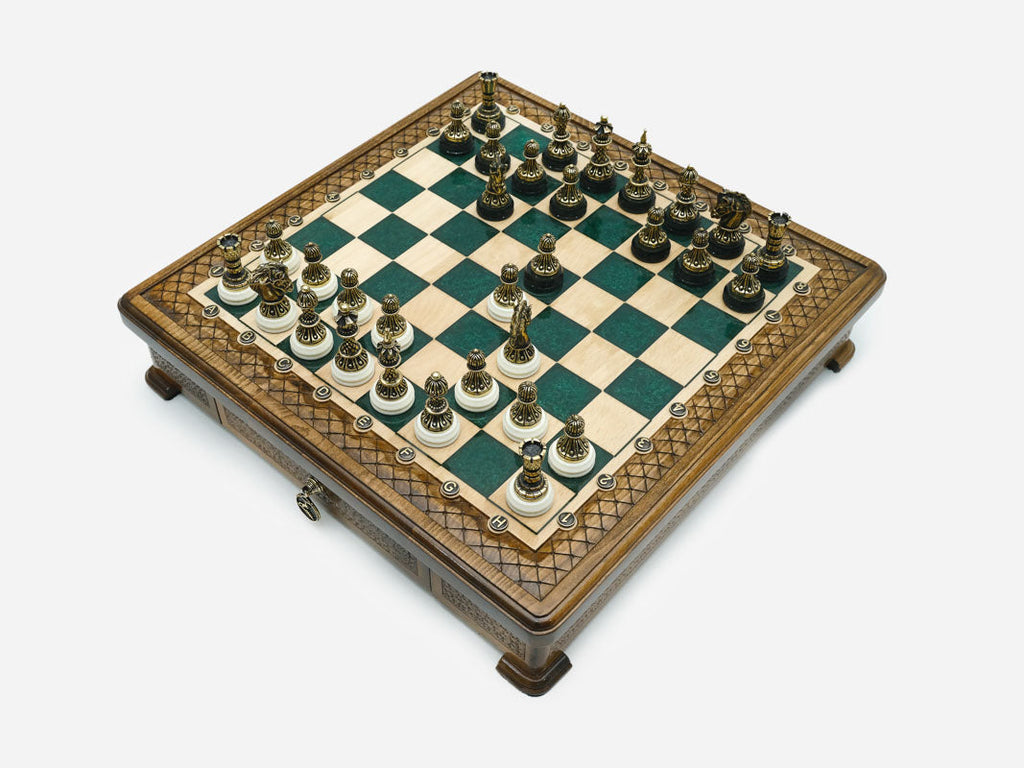 Green epoxy chess set set up for play, angled top-down view