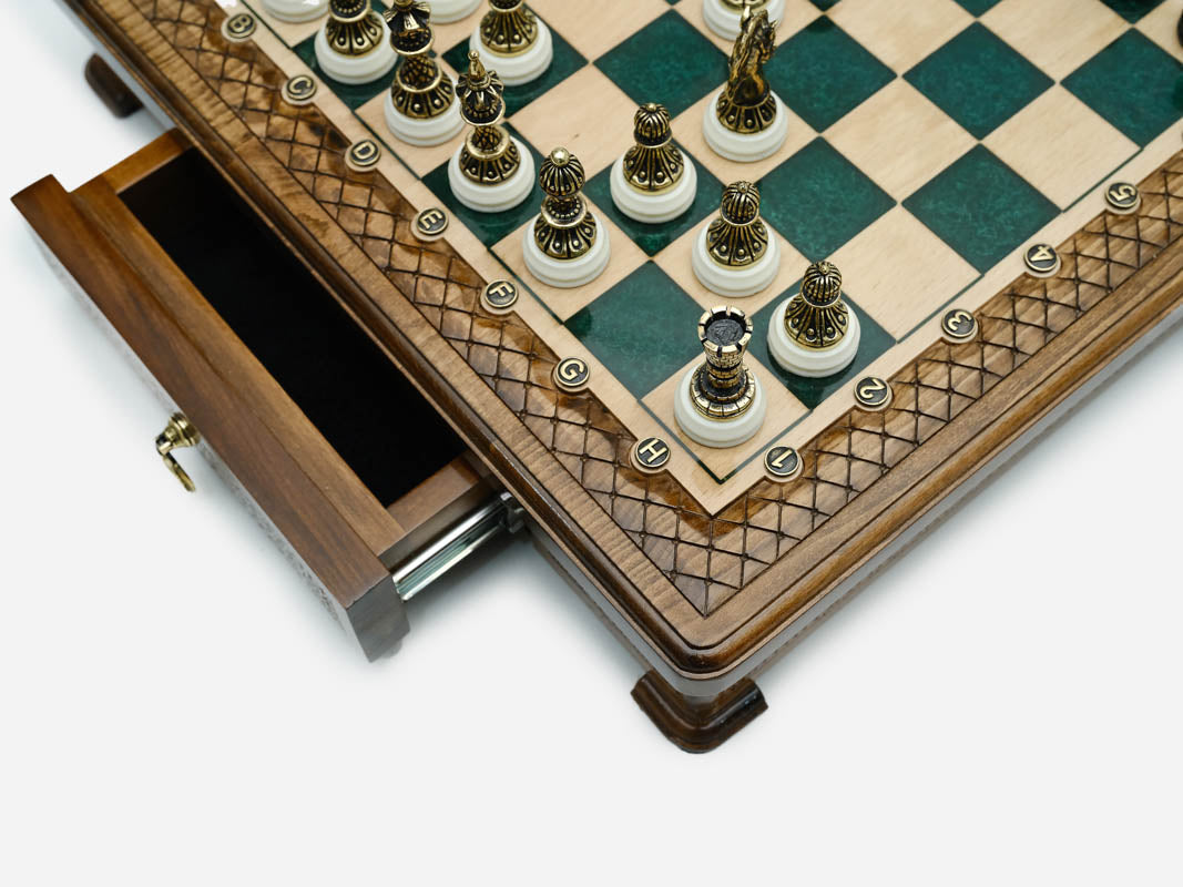 Close-up of the drawer corner and bronze chess pieces on the green epoxy set