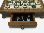 Close-up of the green epoxy chess set drawer with bronze pieces stored inside