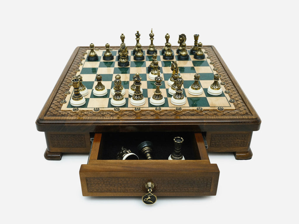 Green epoxy chess set with the storage drawer open showing spare pieces