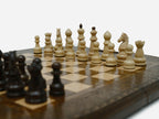 Detail of the turned chess pieces on the maple and walnut inlaid squares