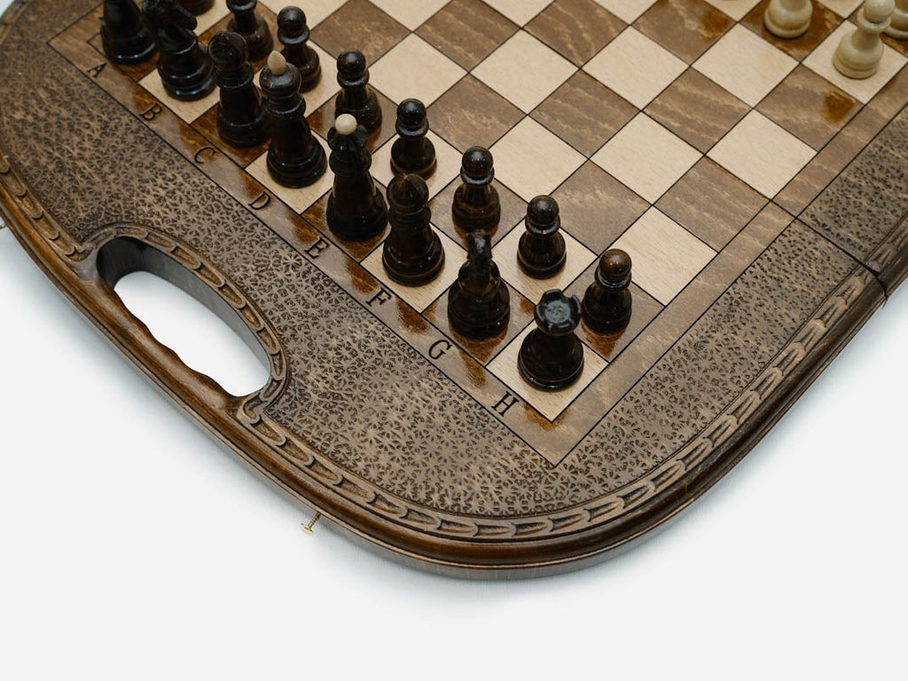 Overhead view of the chess board with the full set of light and dark pieces