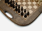 Overhead view of the chess board with the full set of light and dark pieces
