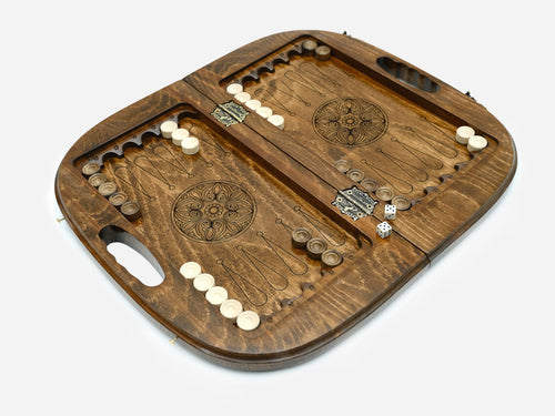 Board open to the backgammon field inside with line-work points, a floral wheel in each half, checkers and dice