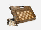 Classic folding chess set standing open, showing the playing face, carved lattice border and built-in carry handle