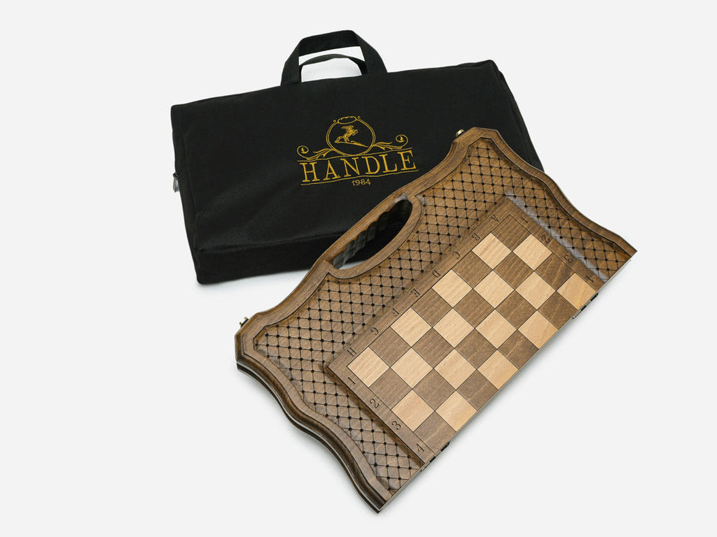The folding chess board beside its black carrying bag