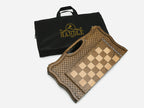 The folding chess board beside its black carrying bag