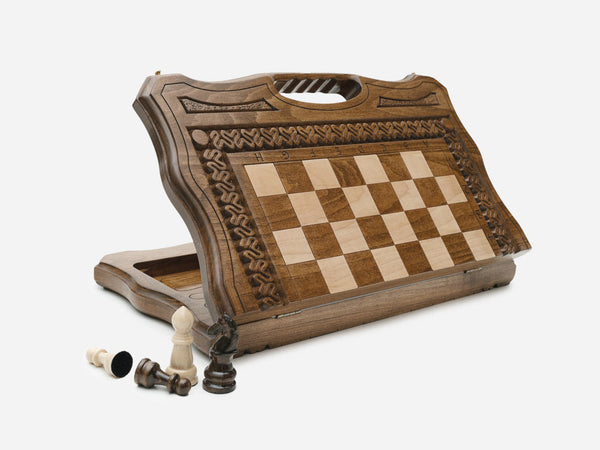 Top-down view of the opened carved chess set with its rope-carved border and beech and walnut pieces