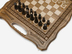 The folding chess board standing open, showing its playing face, rope border and carry handle