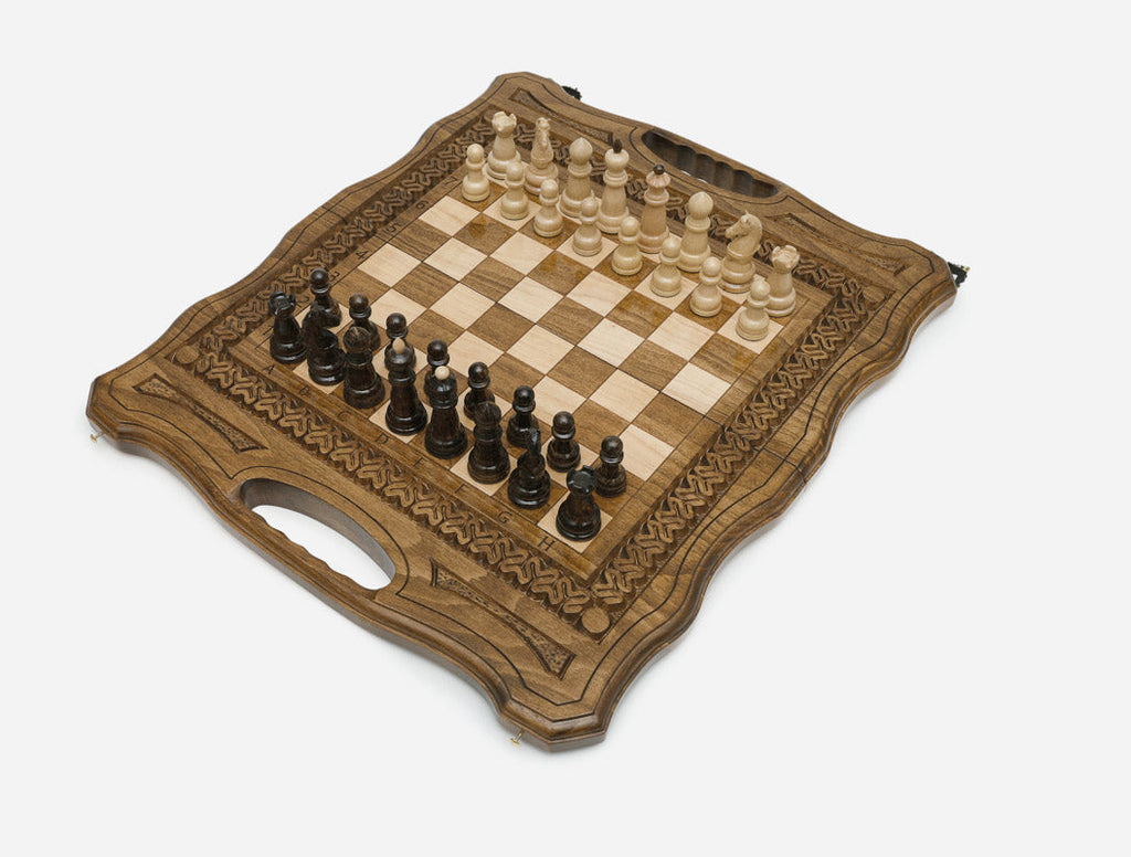Angled view of the carved folding chess board set up for play