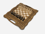 Angled view of the carved folding chess board set up for play