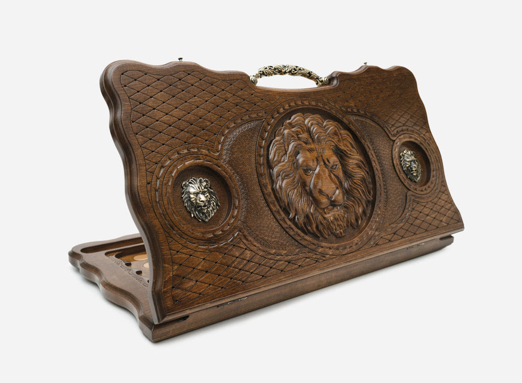 Luxury carved backgammon board with a lion, two bronze lions and an ornate bronze carry handle, propped open