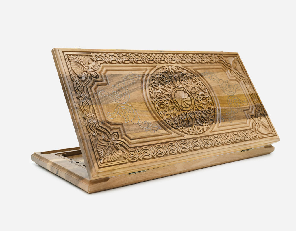 Luxury walnut backgammon board with real silver inlay and a carved central ornament, shown propped open