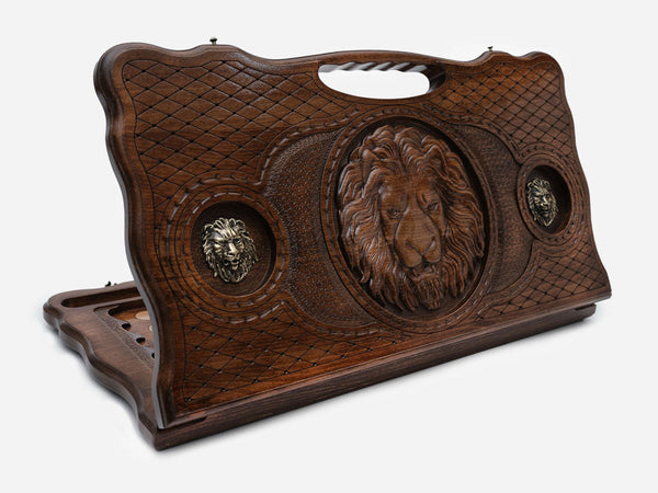 Carved beechwood backgammon board with a lion and bronze lions, with a carry handle, propped open
