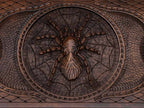 Angled view of the bronze spider carved backgammon board