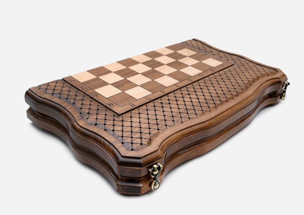 The chess board closed, side view showing the wood finish and brass clasps
