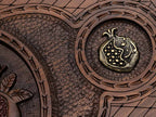 Detail of one of the two smaller bronze pomegranates