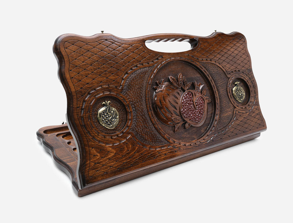 Armenian backgammon board with a bronze pomegranate and a cut-out carry handle, propped open