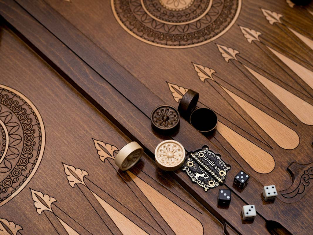 Close-up of the checkers, dice and cup on the central ornament backgammon table