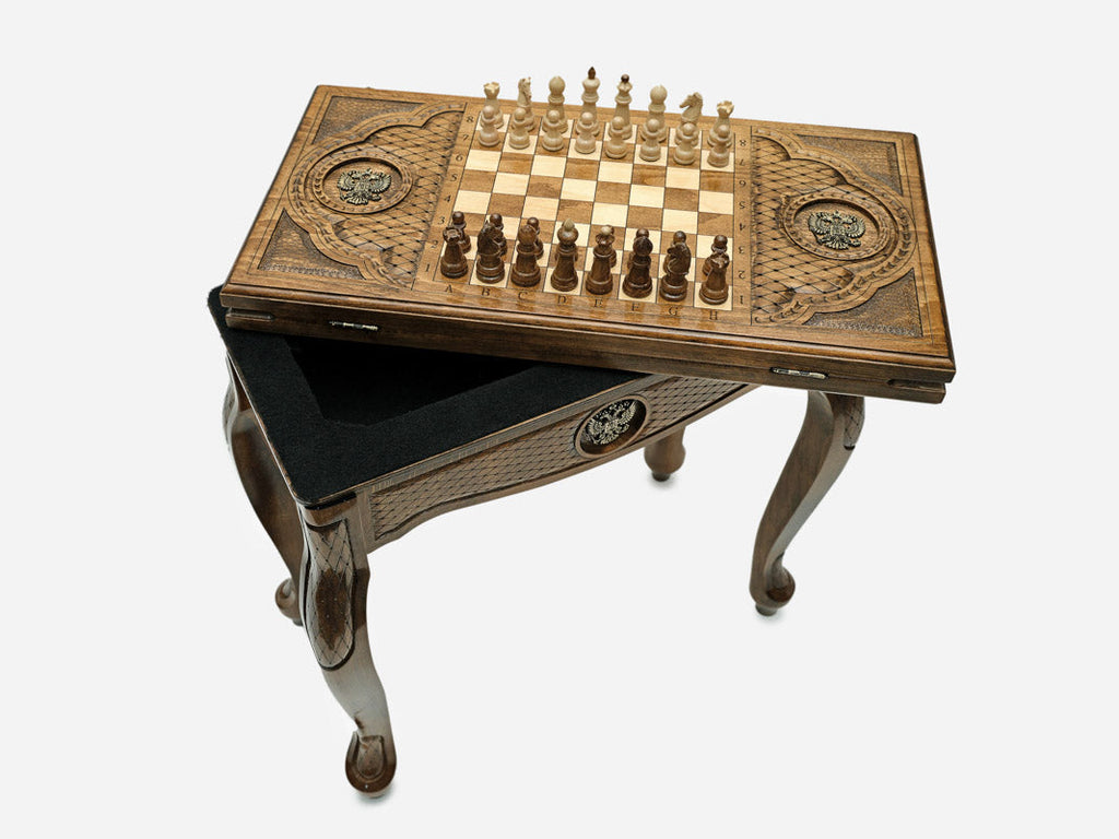 Close-up of the carved leg and drawer front with the bronze double-headed eagle