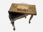 Close-up of the carved leg and drawer front with the bronze double-headed eagle