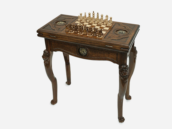 Chess and backgammon table set up for chess, angled view showing the carved lion legs