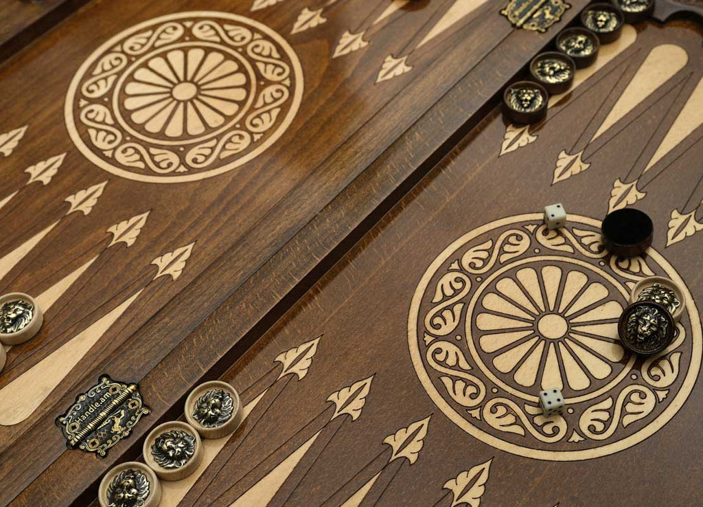 Close-up of the bronze checkers, dice and cup on the lion table
