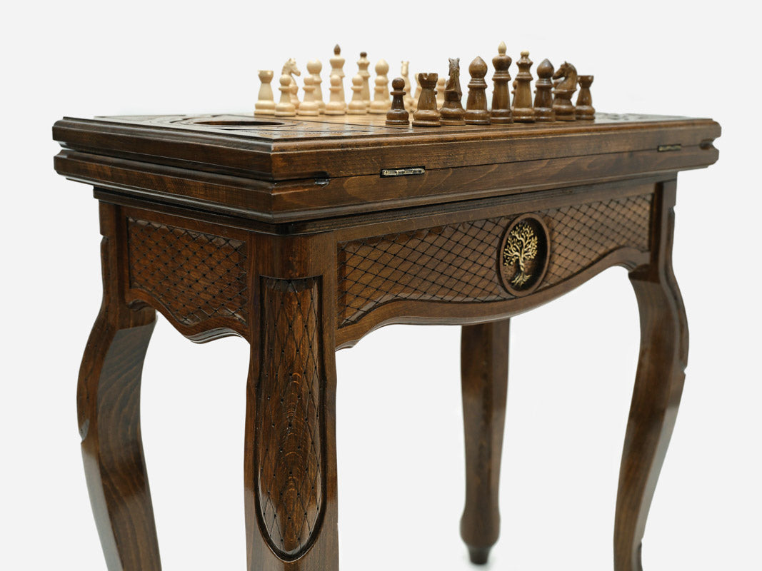 Close-up of the carved leg and drawer front with the bronze Tree of Life