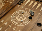 Close-up of the bronze checkers, dice and cup on the Tree of Life table