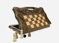 Luxury carved chess set standing open, showing the playing face and the handle carved into the top edge
