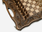 Close-up of the deep ornament and scrollwork carving framing the playing field