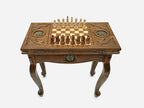 Close-up of the carved leg and drawer front with the bronze coat of arms