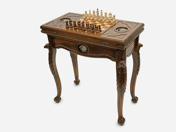 Chess and backgammon table set up for chess, angled view showing the carved eagle legs