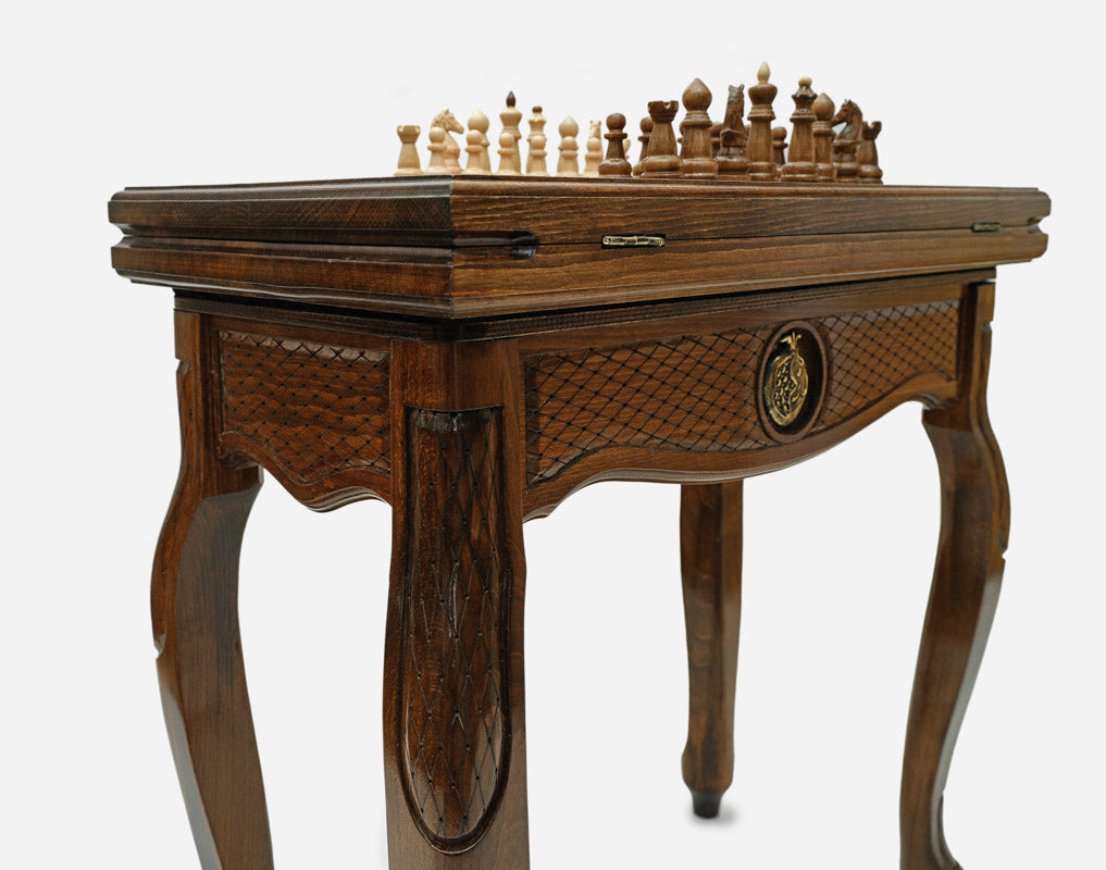 Close-up of the carved leg and drawer front with a bronze pomegranate