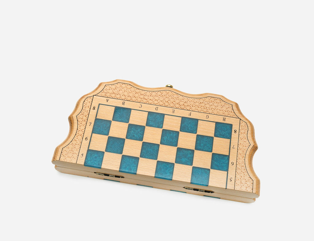Side angle of the blue epoxy chess set showing its slim folded depth