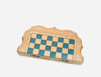 Side angle of the blue epoxy chess set showing its slim folded depth