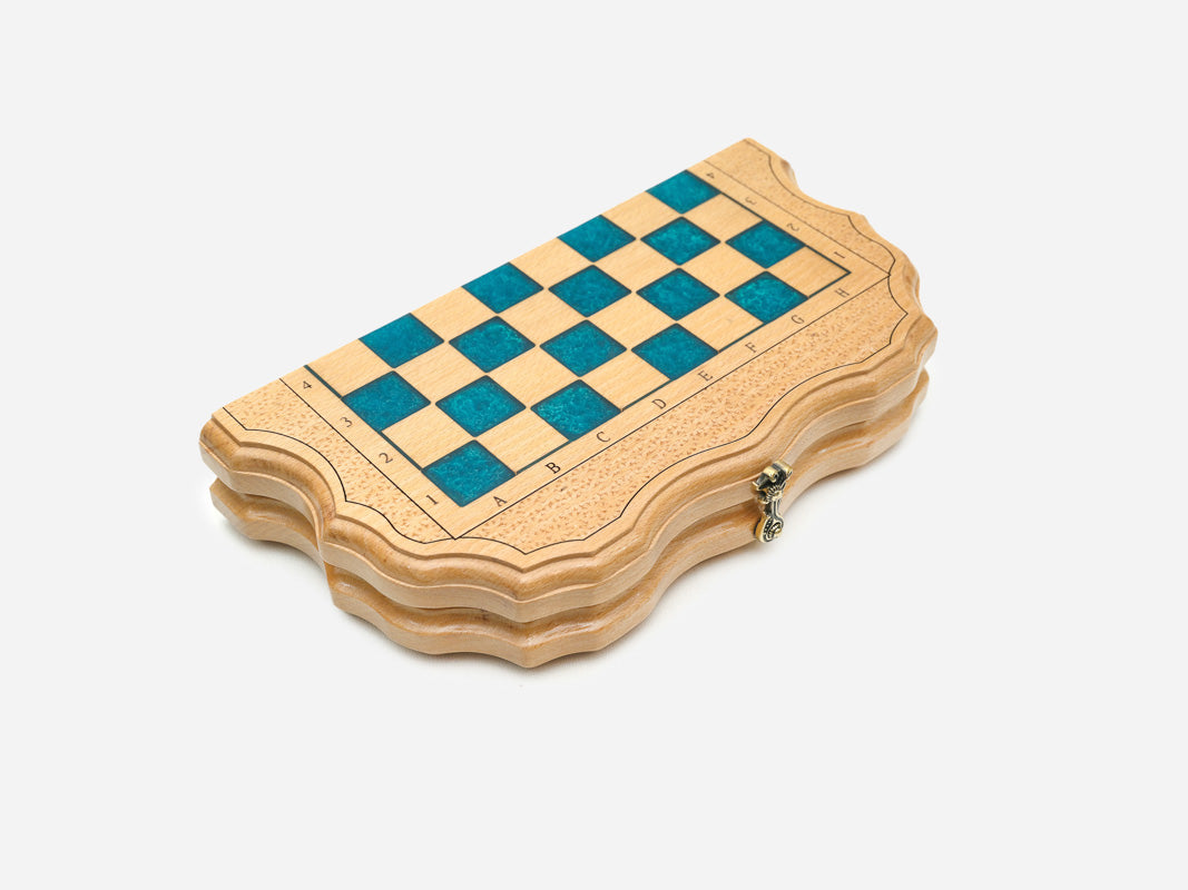 The travel chess set shown closed on its bronze hinges